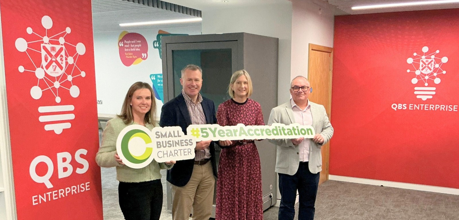 Four people with Small Business Charter logo